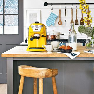kitchen room with grey coloured kitchen counter with wooden worktop and yellow coffee machine