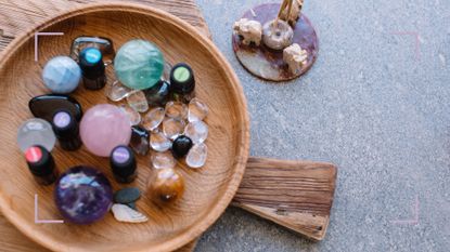 Healing crystals in a wooden bowl to demonstrate how to use crystal in the house