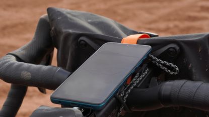 Smartphone mounted on a gravel bike for a bikepacking loop around Morocco