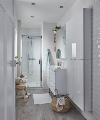 small narrow bathroom with white slimline cabinets