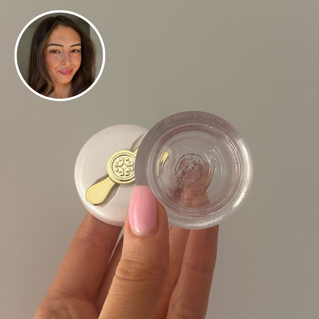 Hand holding an empty tub of Tatcha The Kissu Lip Mask, with circular photo of Sennen Prickett in top left corner