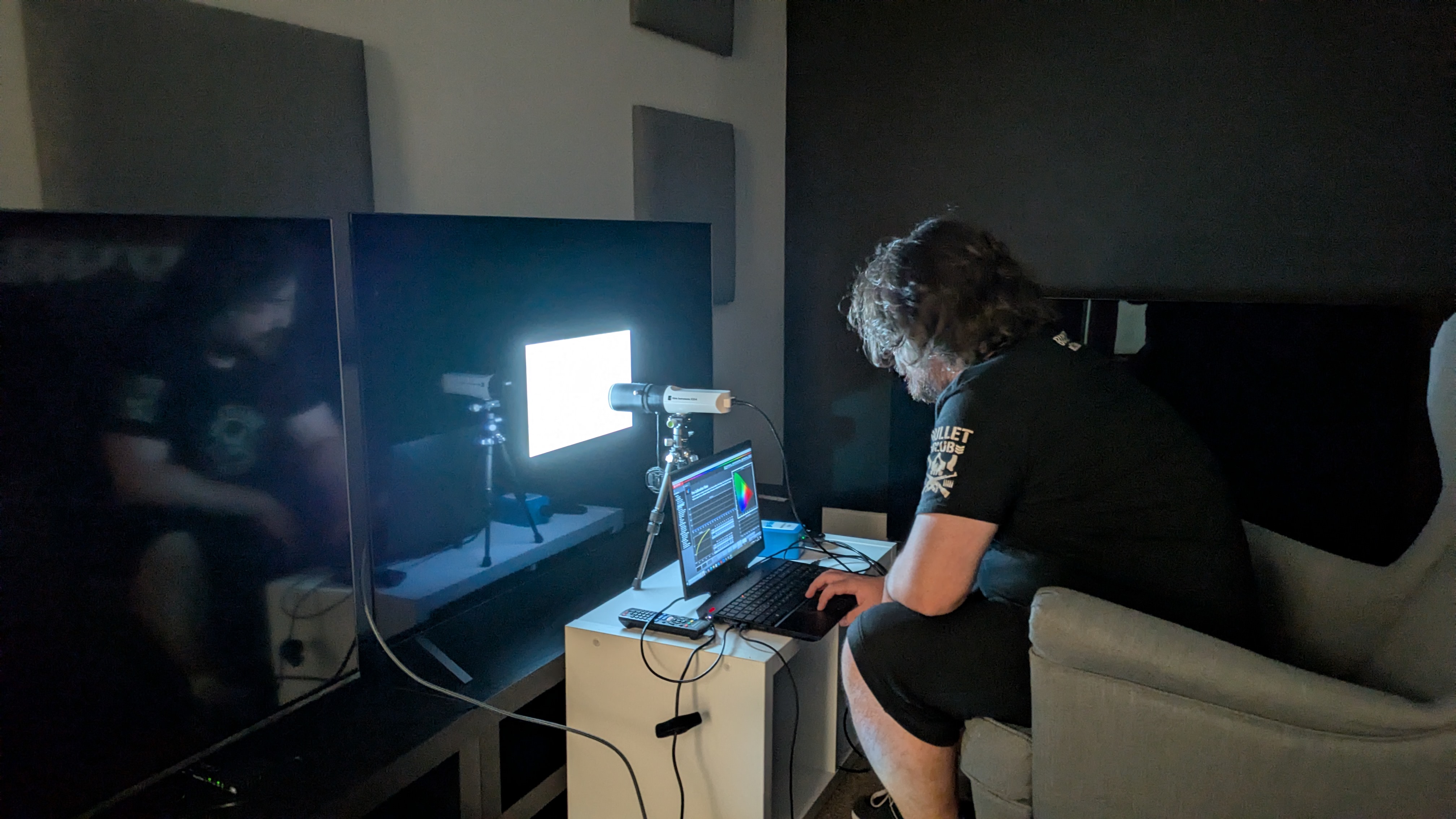 LG B5 OLED TV with testing equipment attached and person testing