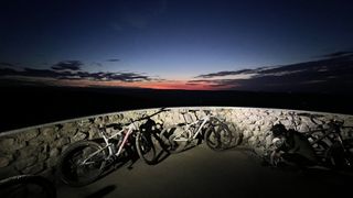 Bikes against wall at sunrise