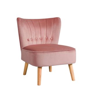 A pink accent chair with wooden legs