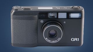 The Ricoh GR1 camera on a blue background