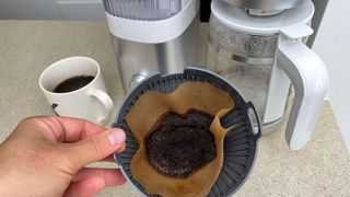 A bloomed coffee filter pre-infused in the Zwilling Enfinigy Drip Coffee Maker