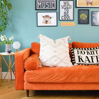 green living room with orange sofa