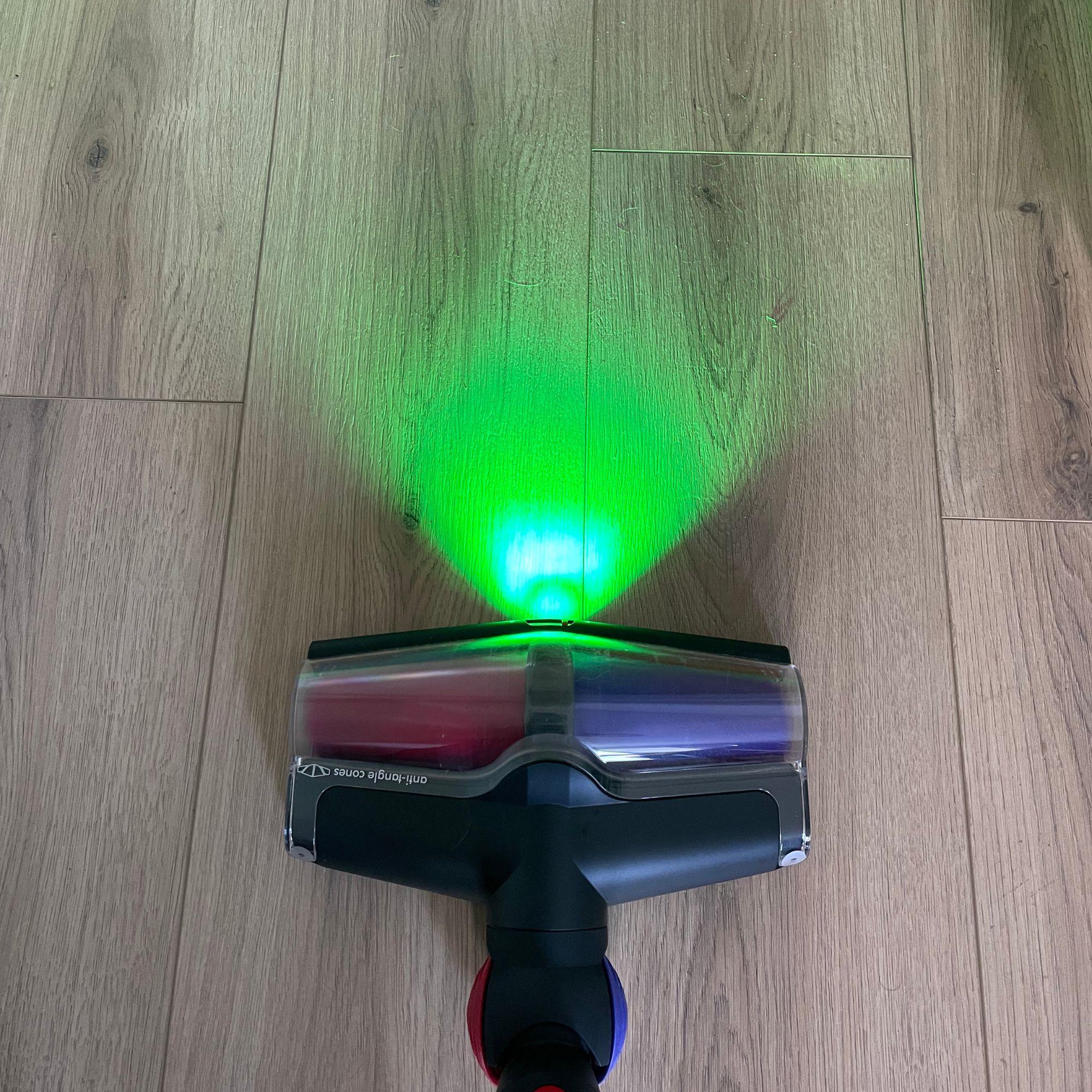Using the Dyson V16 Piston Animal on wood-effect floor, with the laser in front of it