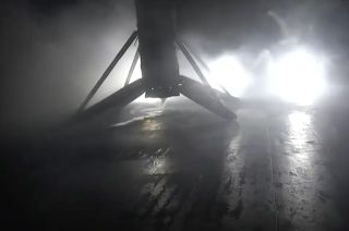 A SpaceX Falcon 9 rocket's first stage is seen after landing on the "Of Course I Still Love You" droneship stationed in the Pacific Ocean on Friday, Dec. 8, 2023.