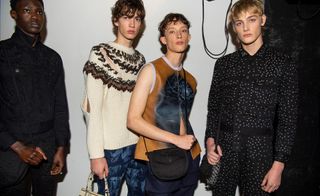 4 male models in dark clothing & knitwear