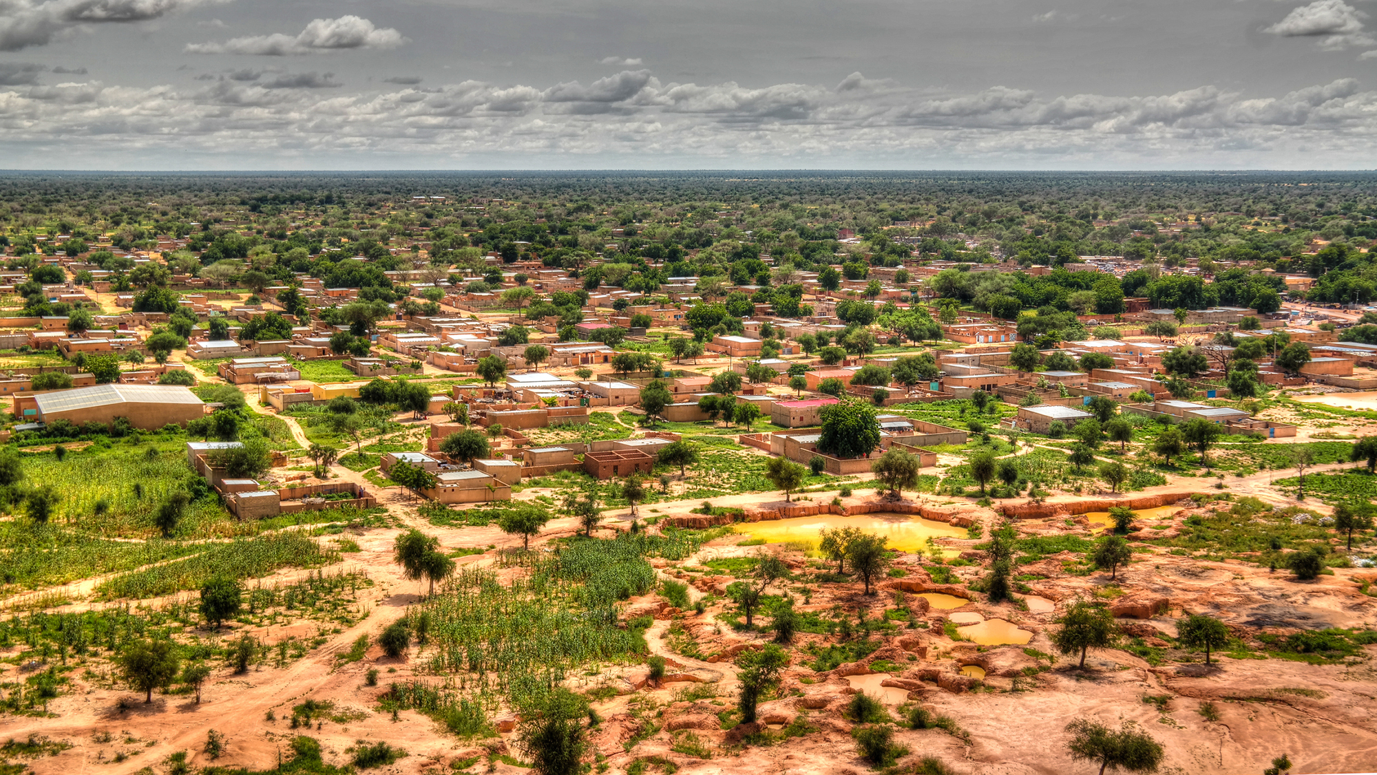 A panorama view of a village in a desert oasis.