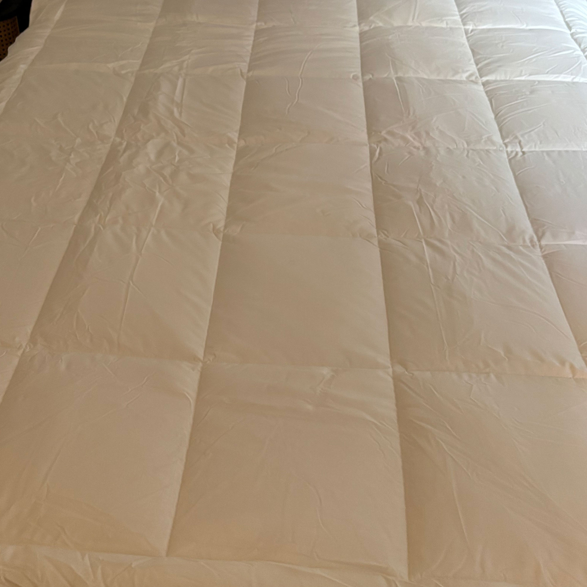 Mattress topper on a mattress on a grey bed
