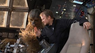 Director Rian Johnson with Chewbacca (a role shared by Peter Mayhew and Joonas Suotamo) in the Millennium Falcon cockpit set