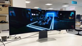 Samsung Odyssey OLED G9 monitor with Cyberpunk 2077 car on screen sitting on white desk