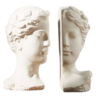 A white bust of a female head cut in half to make two bookends