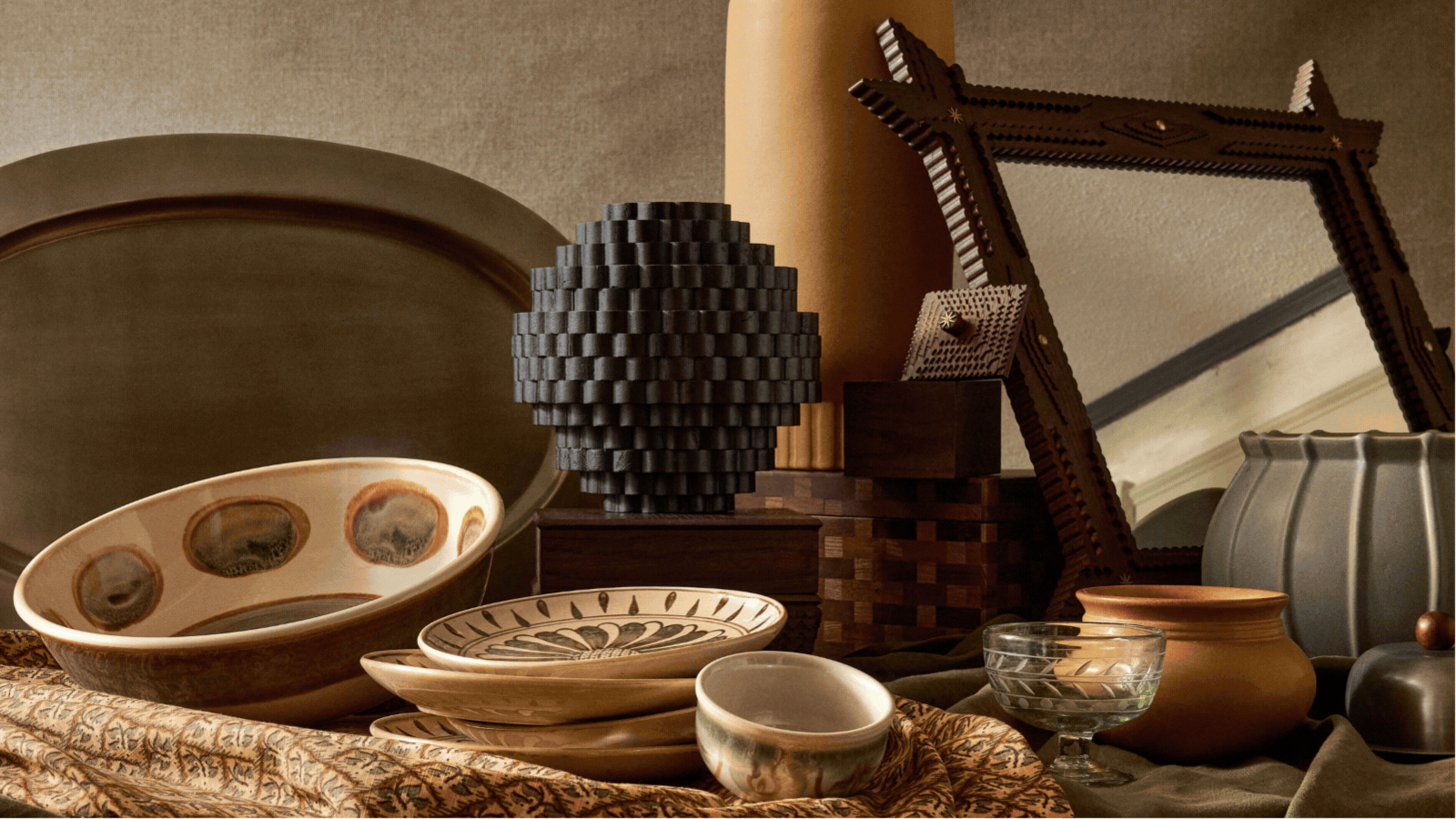 Rotating GIF of four images showing different homeware products styled in different ways. There are lots of vases, wicker baskets, ceramic plates, and wood and leather pieces. 