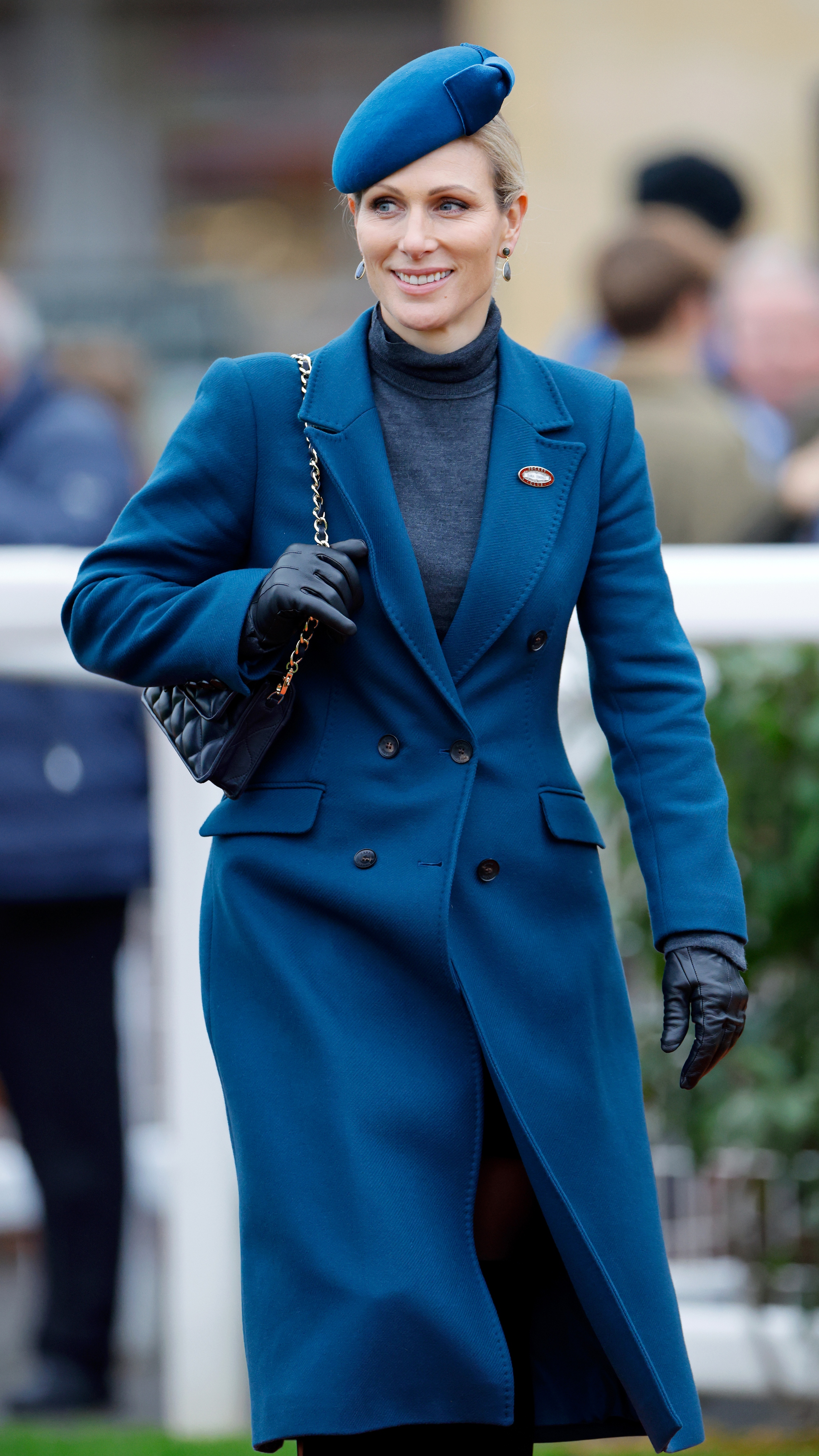 Zara Tindall holds the strap of her handbag as she attends day 2 &#039;Super Saturday&#039; of The November Meeting at Cheltenham Racecourse