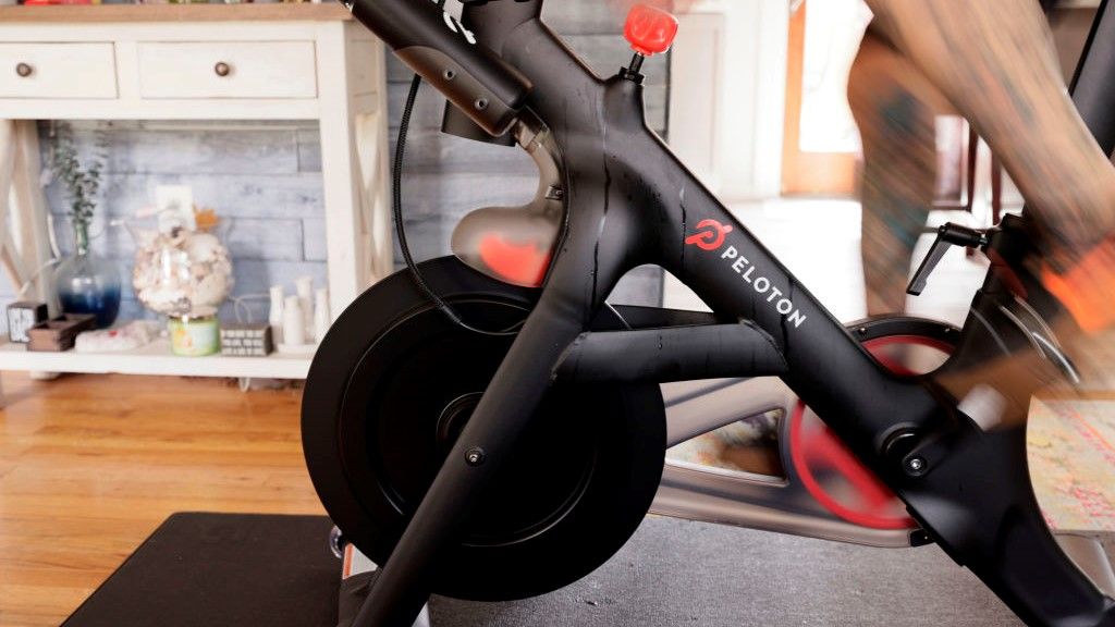 a photo of a man on a peloton bike at home 