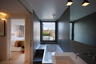 an ensuite bathroom in a loft conversion with a pocket door