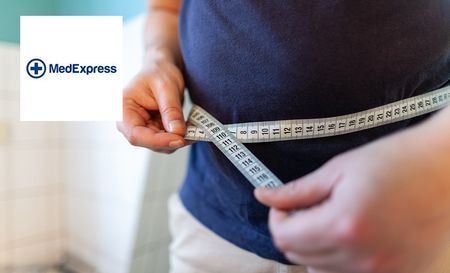 Man measuring his stomach and keep a record of his weight loss
