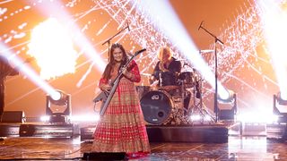 Maya Neelakantan playing guitar on the America&#039;s Got Talent stage