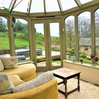 conservatory area with french door and yellow sofa