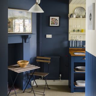 kitchen area with blue wall and firpalce and chair