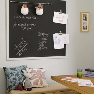 office with hanging chalkboard and cushion