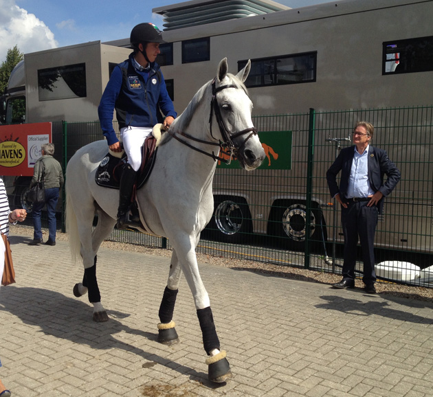 Aachen show director Frank Kemperman shares a word with Irish rider Bertram Allen, on Molly Malone V, outside the stables