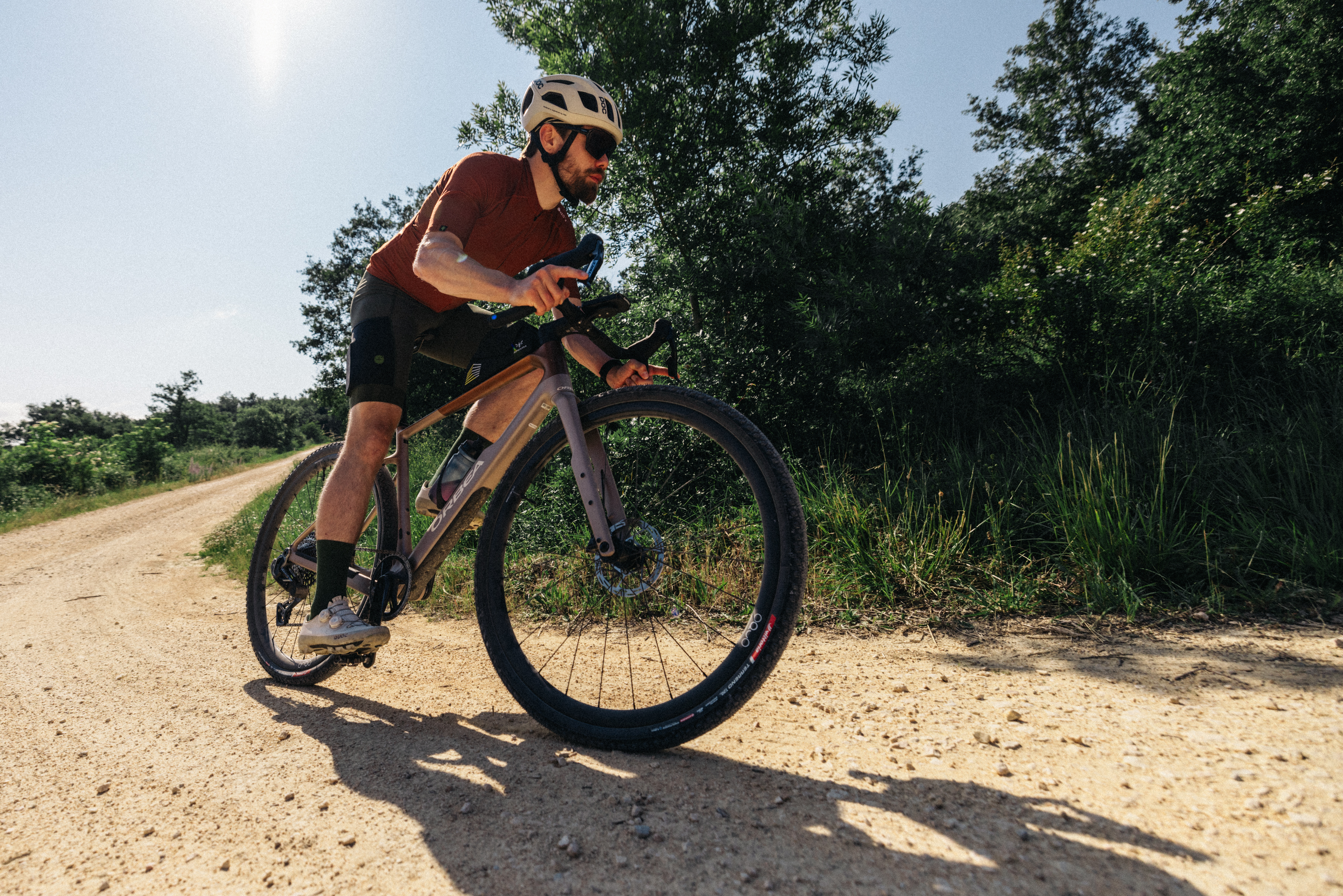 A man riding the new Orbea Terra gravel bike around a gravel corner