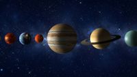 An illustration of the planets in our solar system lined up against a blue starry background, with Venus then Earth, Mars, Jupiter, Saturn and Uranus