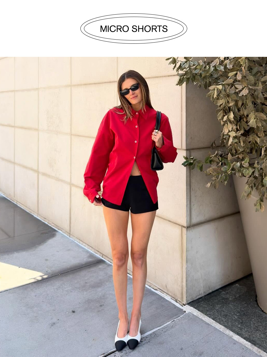 Influencer wearing black micro shorts with a red button-down