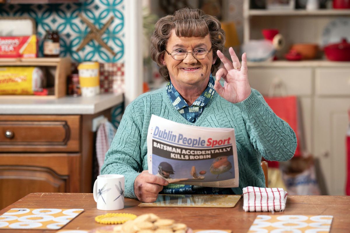 Brendan O&#039;Carroll as Agnes Brown reading a newspaper.