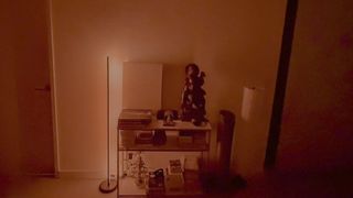 Nanoleaf Smart Multicolor Floor Lamp display red light beside a console table