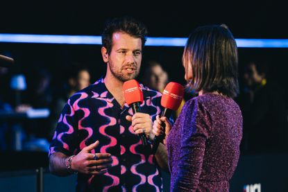 Adam Blythe holding a red microphone