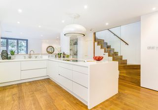 kitchen with wooden flooring and white cabinet