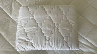 The top of the John Lewis Soft Touch Washable Quilted Mattress Protector on a mattress