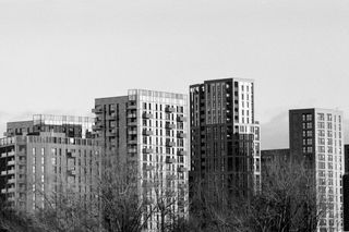 Apartment blocks set against a grey sky taken on Ilford HP5 Plus 35mm film