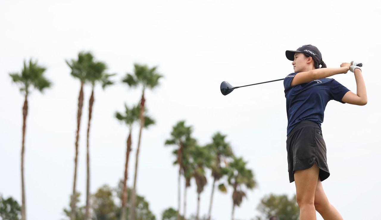 Shuangshuang Fan strikes a tee shot with a driver 