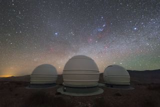 The ExTrA telescopes at ESO's La Silla Observatory in Chile will be used to locate and analyze Earth-size planets orbiting nearby red dwarf stars. ExTrA's new design allows for greater sensitivity compared to previous searches. In this nighttime image, the ExTrA three domes are seen under a beautiful sky featuring the constellation Orion (the Hunter) and the Pleiades star cluster.