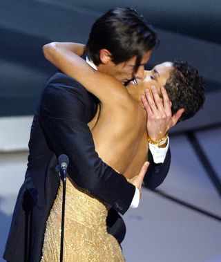 Actor Adrien Brody kisses presenter Actress Halle Berry as he accepts his Oscar for Performance by an actor in a leading role for his role in "The Pianist" during the 75th Academy Awards at the Kodak Theatre in Hollywood, California, 23 March, 2003.