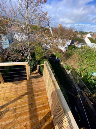 View from the top of the timber decking at the bottom of the property's garden overlooking neighbour's yards