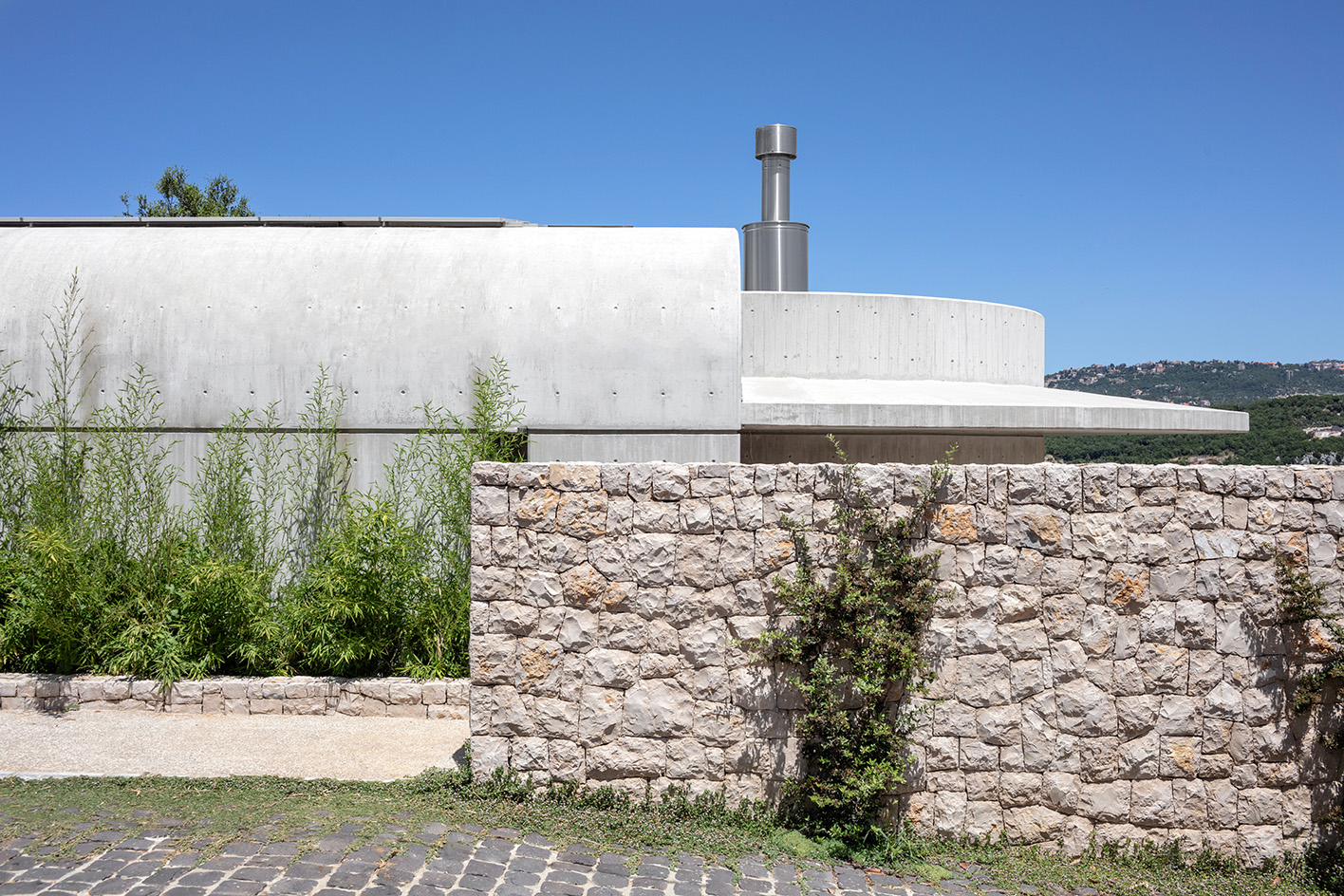 Capsule Retreat by East Architecture Studio, a concrete house in the leafy countryside with tall ceilings and minimalist interiors