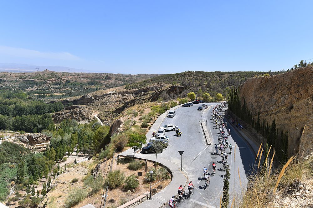 The peloton are strung out on the climb