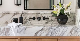bathroom sink in white and black veined marble to show key bathroom trend 2023