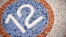 The number 12 displayed on a mosaic floor.