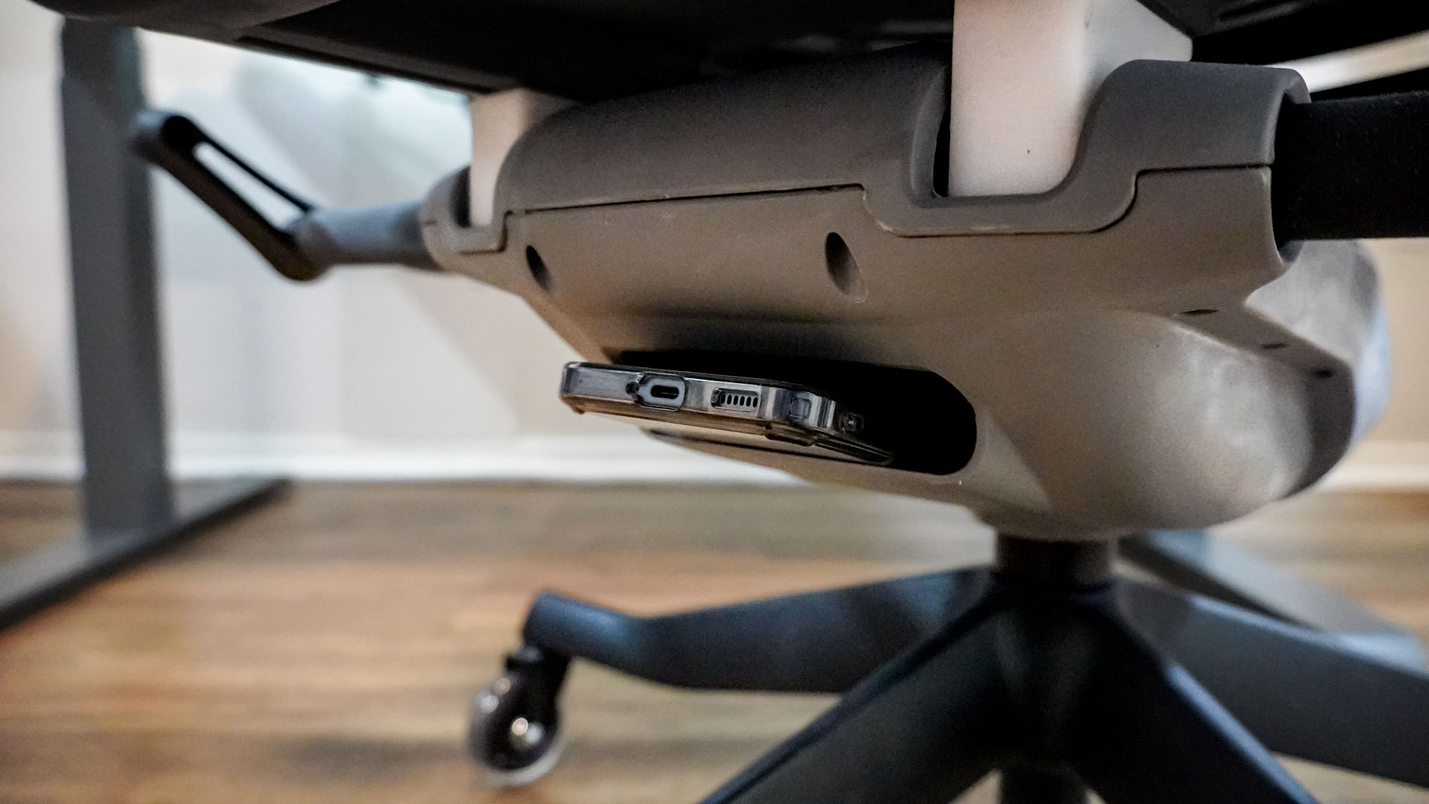The Uplift Pursuit office chair with a phone stored in its under-seat storage compartment