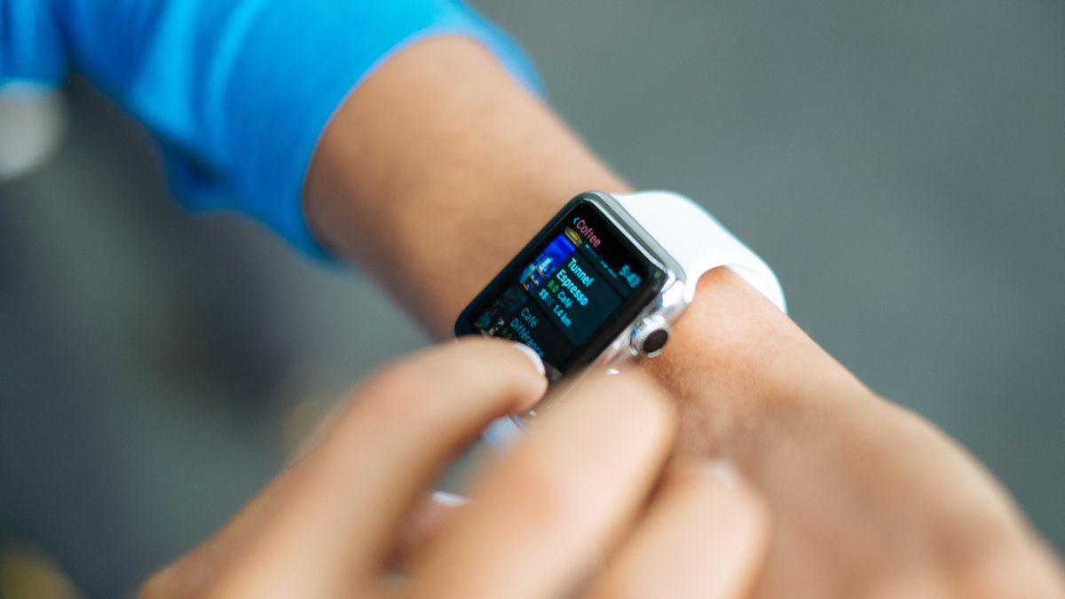 Woman checks smartwatch. Photo by Luke Chesser on Unsplash