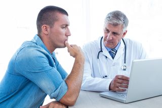 A doctor talks with a male patient.
