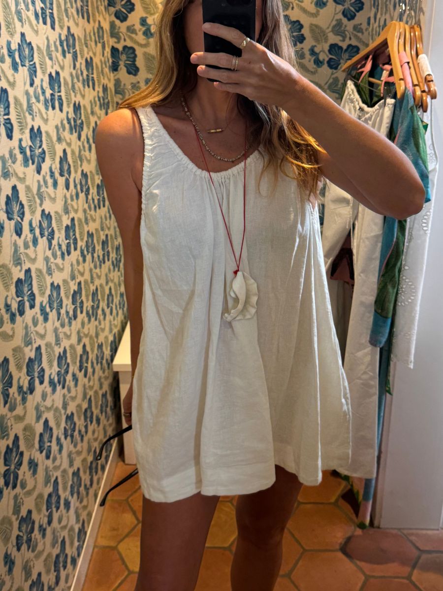 Angie wears a white dress by Free People.